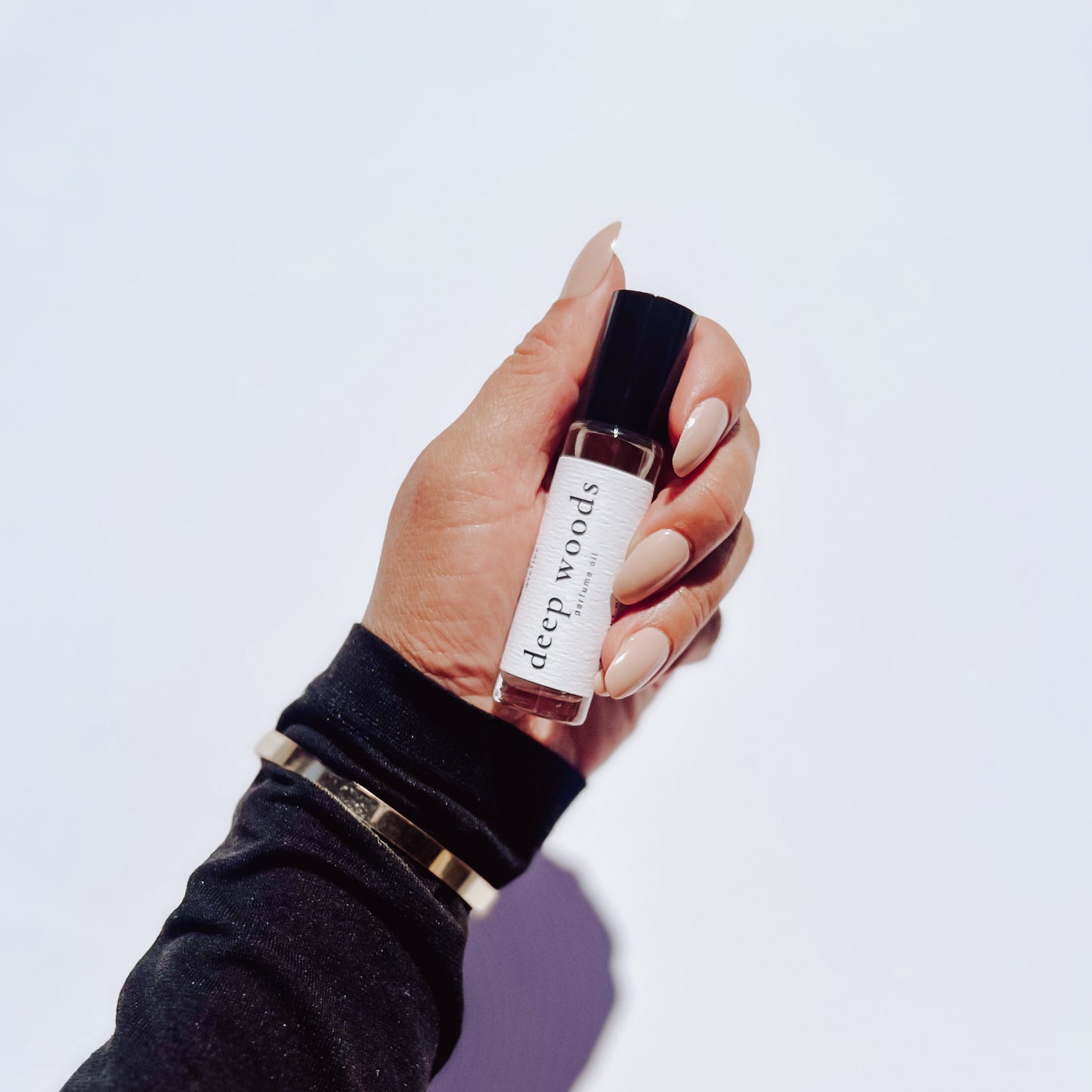Deep woods perfume in hand