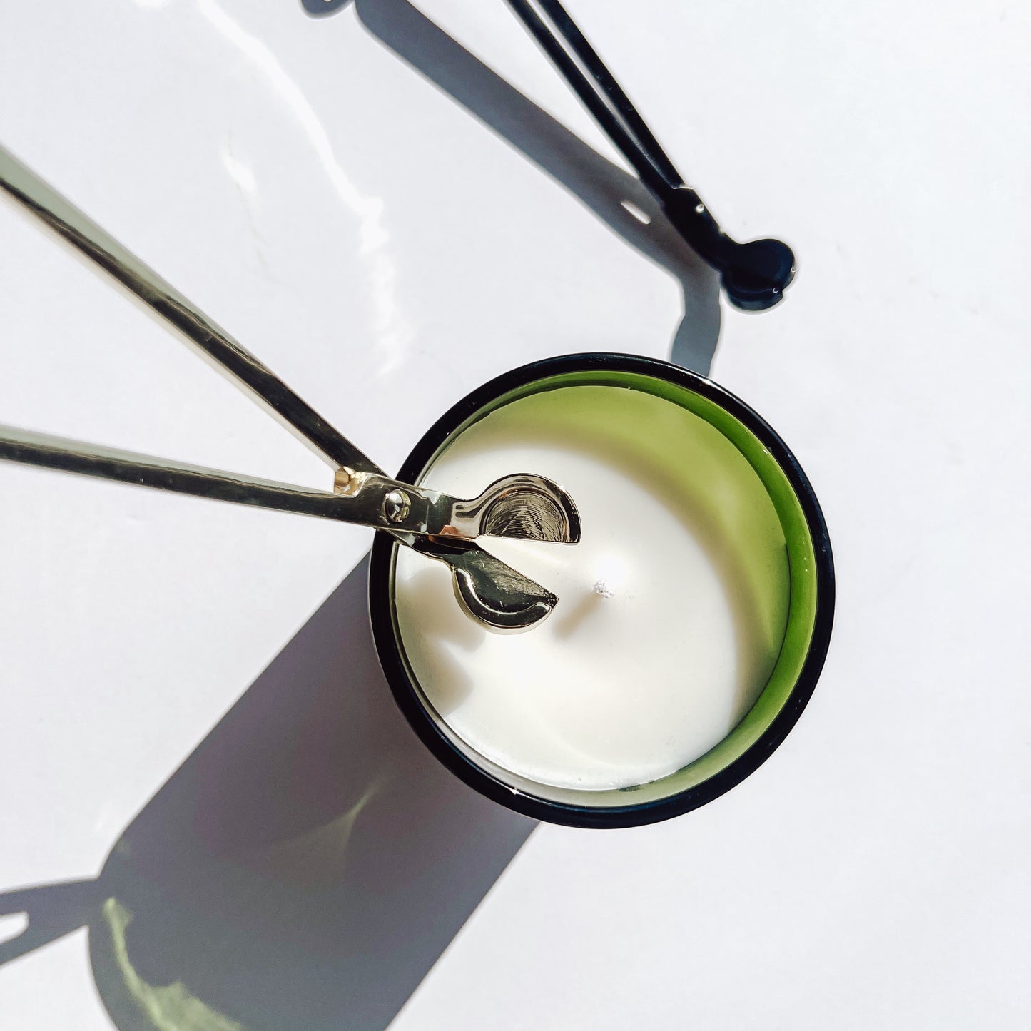 gold wick trimmer being used on cotton wick
