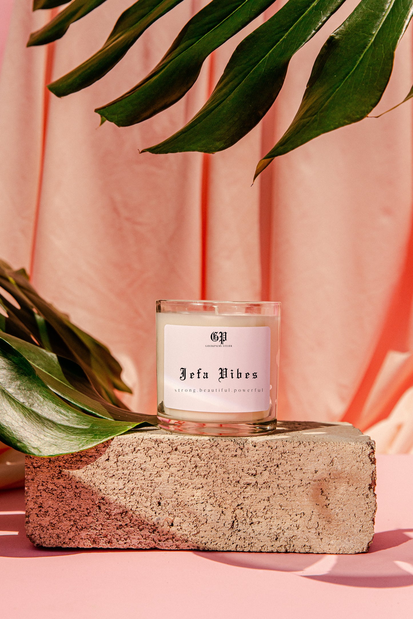 jefa vibes candle pink background gold and palms