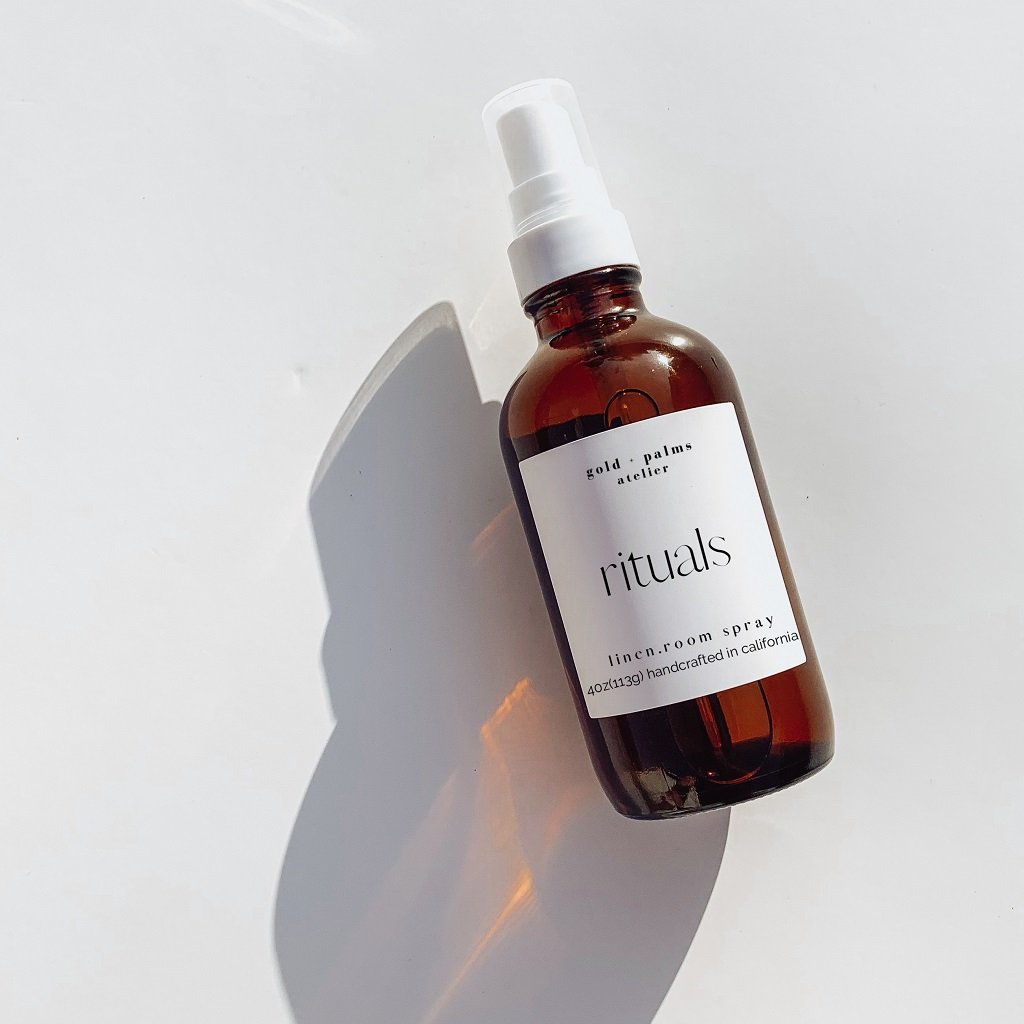 lavender and sage room spray in amber bottle against white background