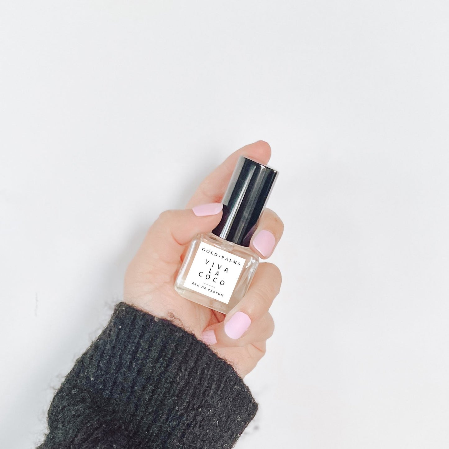 15 ml gender neutral vanilla coconut fragrance help up in front of a white background