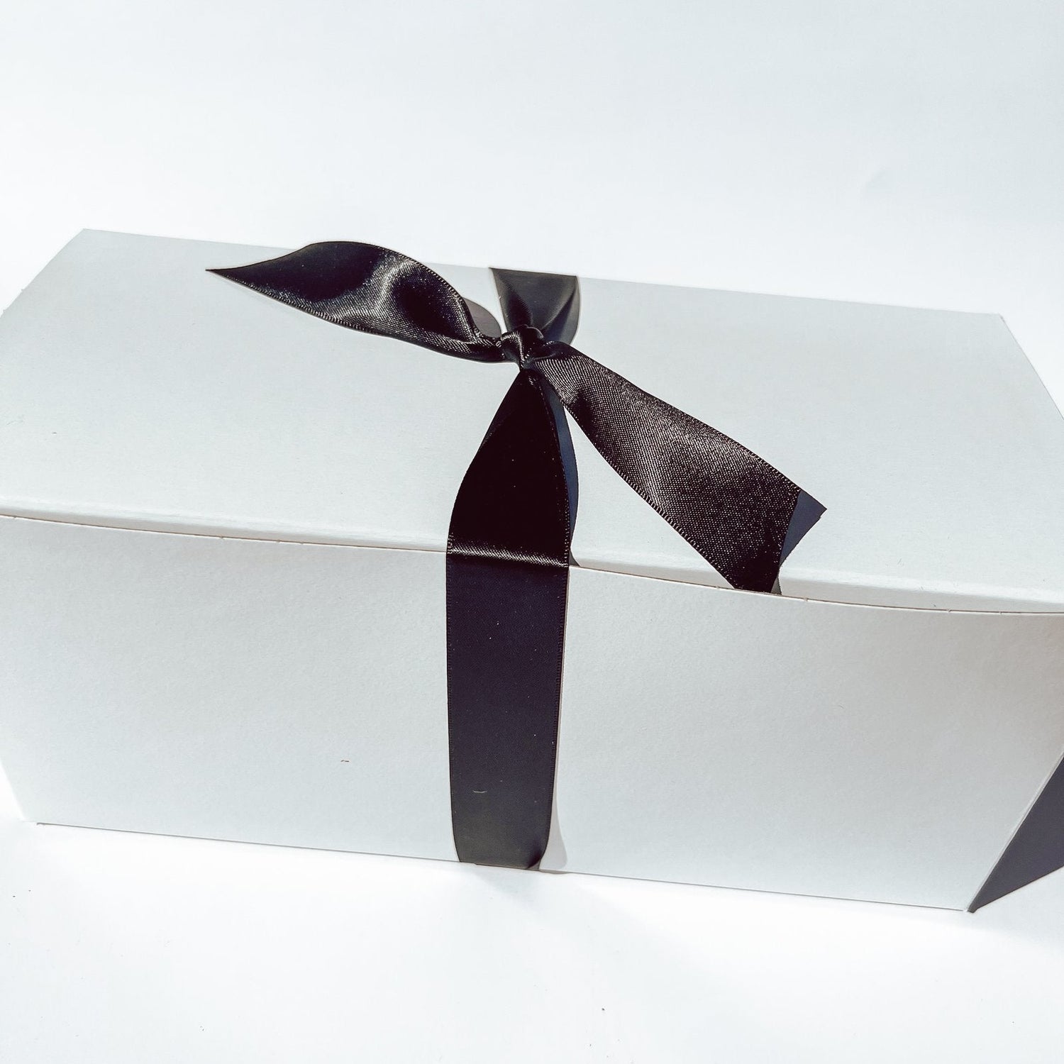 Gold and palms white gift box with black ribbon