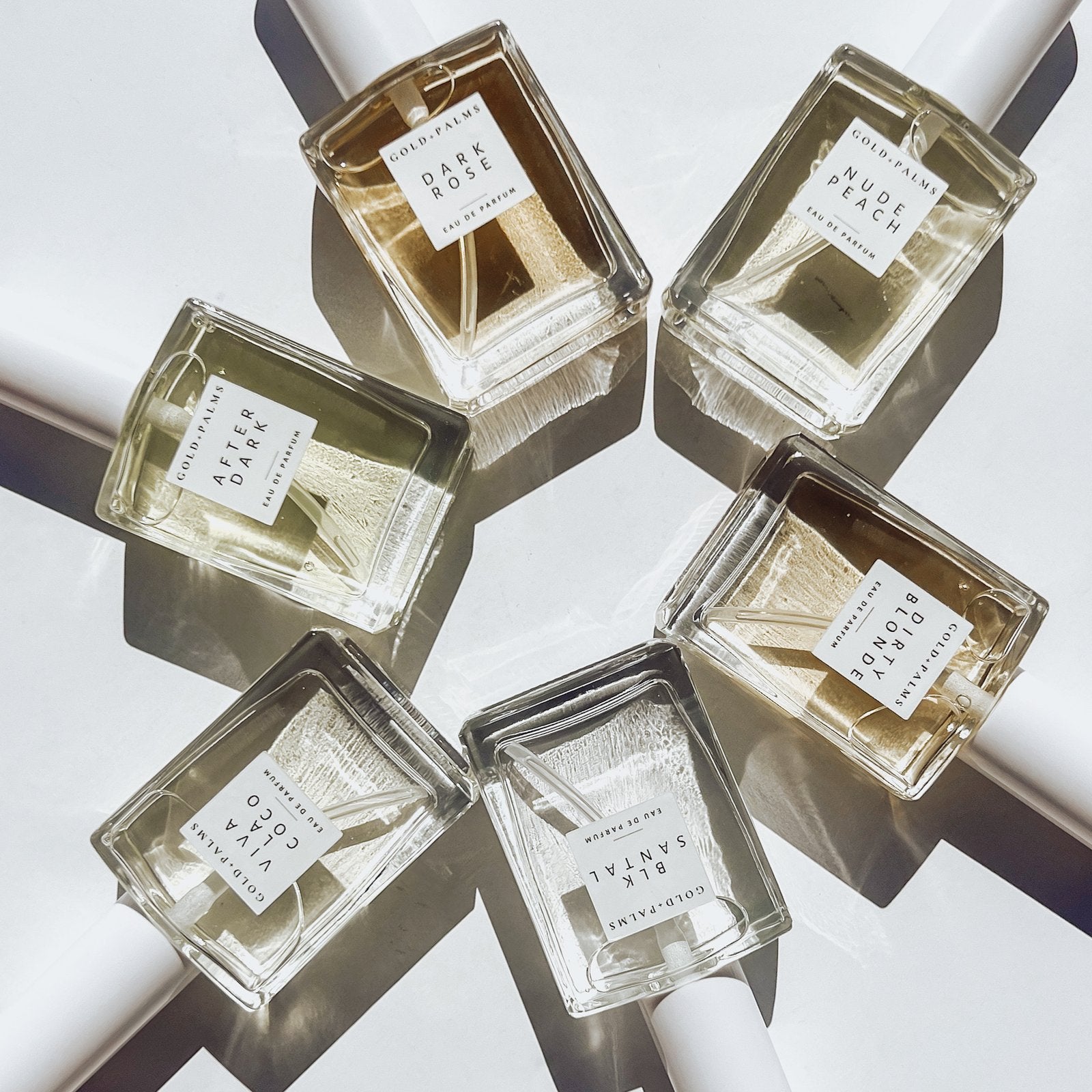 50 ml vanilla perfume atomizers laying in a circle with white background
