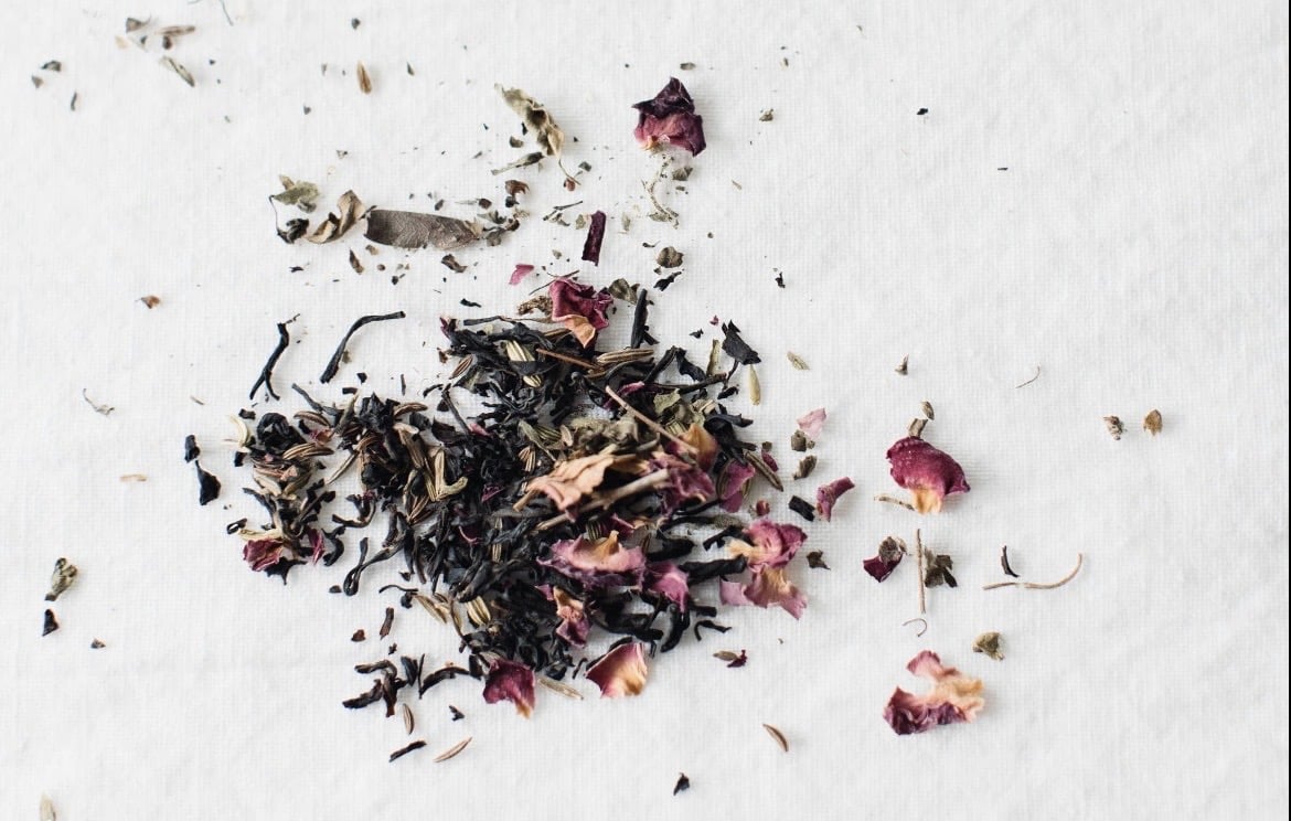 Aesthete tea blend with roses spread on white background 