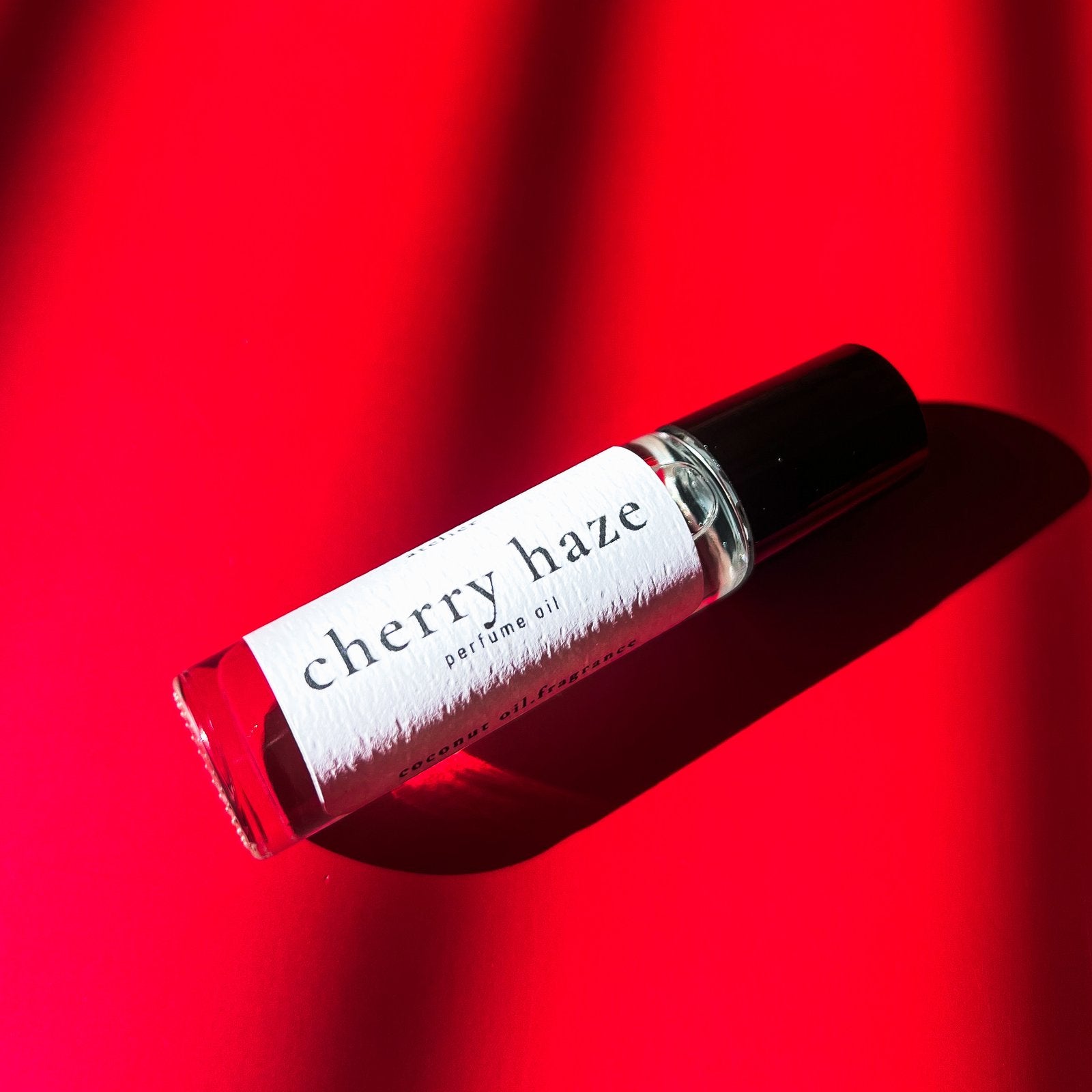 smokey cherry vanilla coconut oil parfum roller ball 10ml with red background