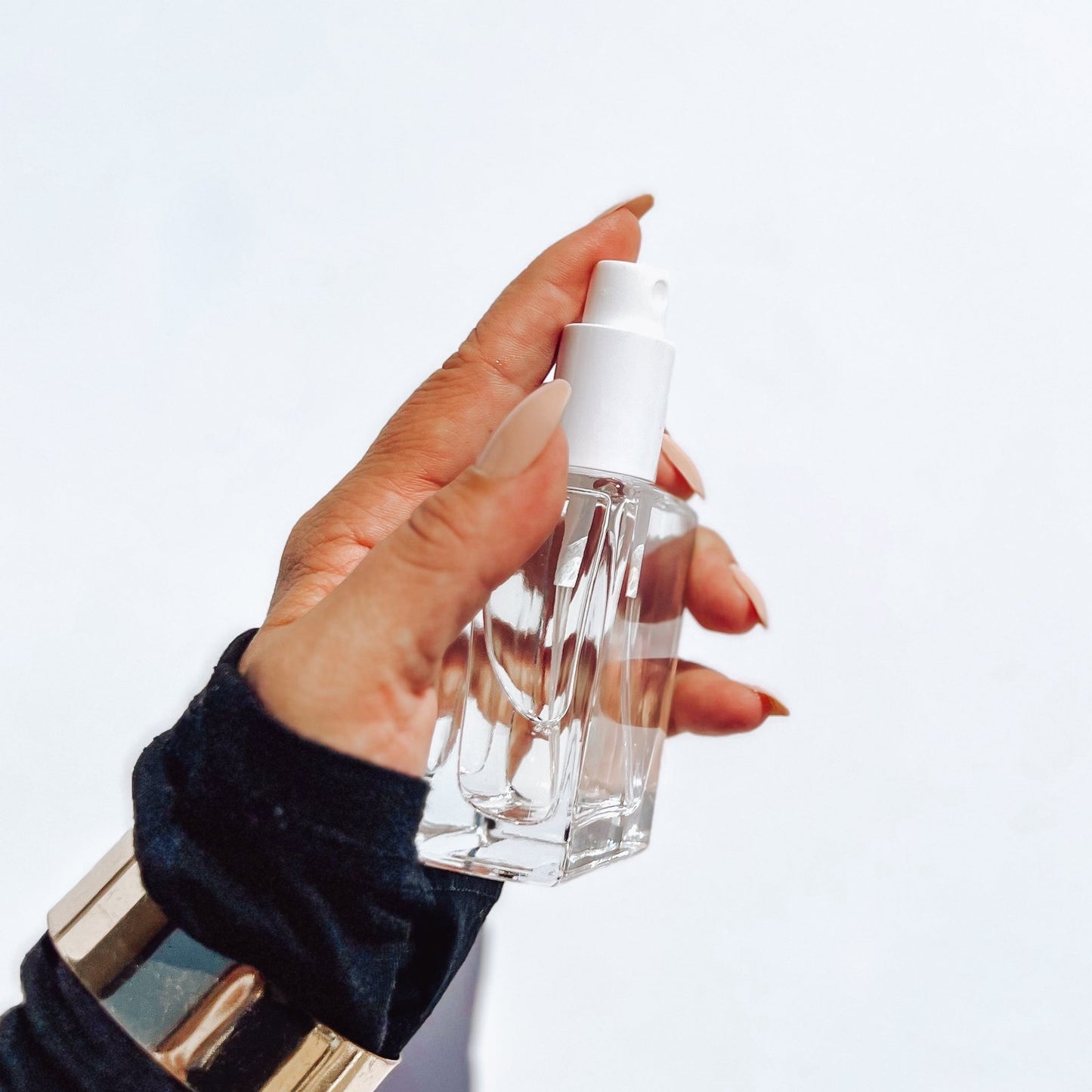 50ml eau de parfum being sprayed by manicure hand 