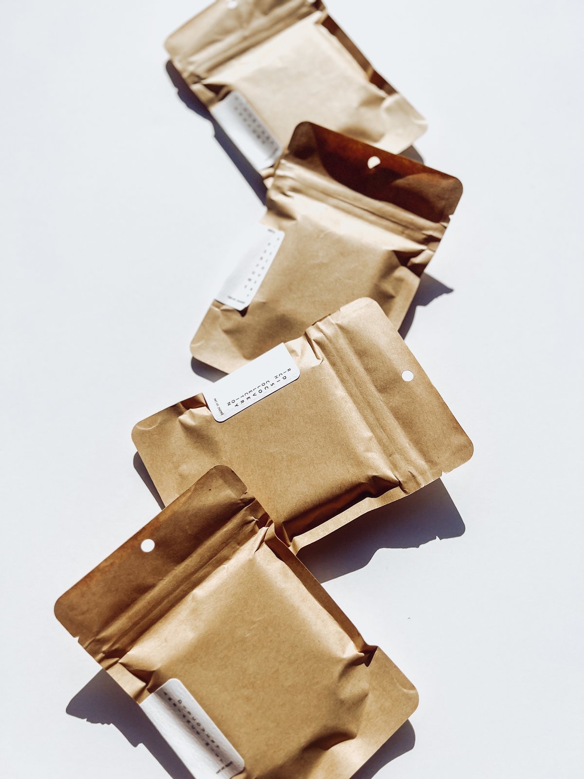 4 packs of gender neutral discovery set in brown paper packaging