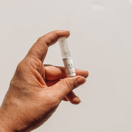 2ml sample layering perfume being held against a white background