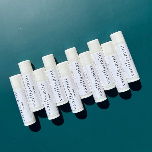 Coconut oil and beeswax lip balms with a green background 