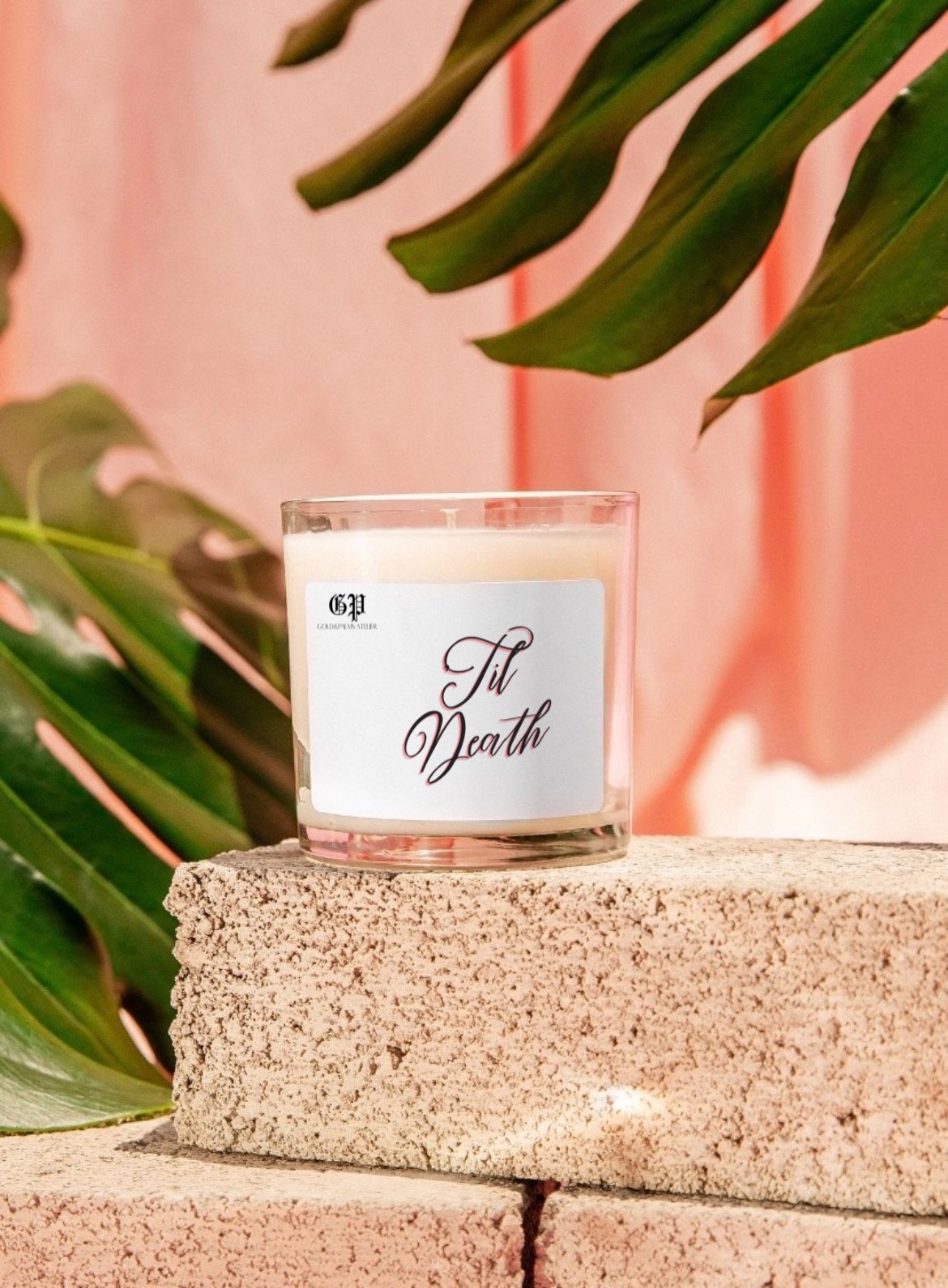 Spiced teakwood candle in clear vessel with tropical background and til death label