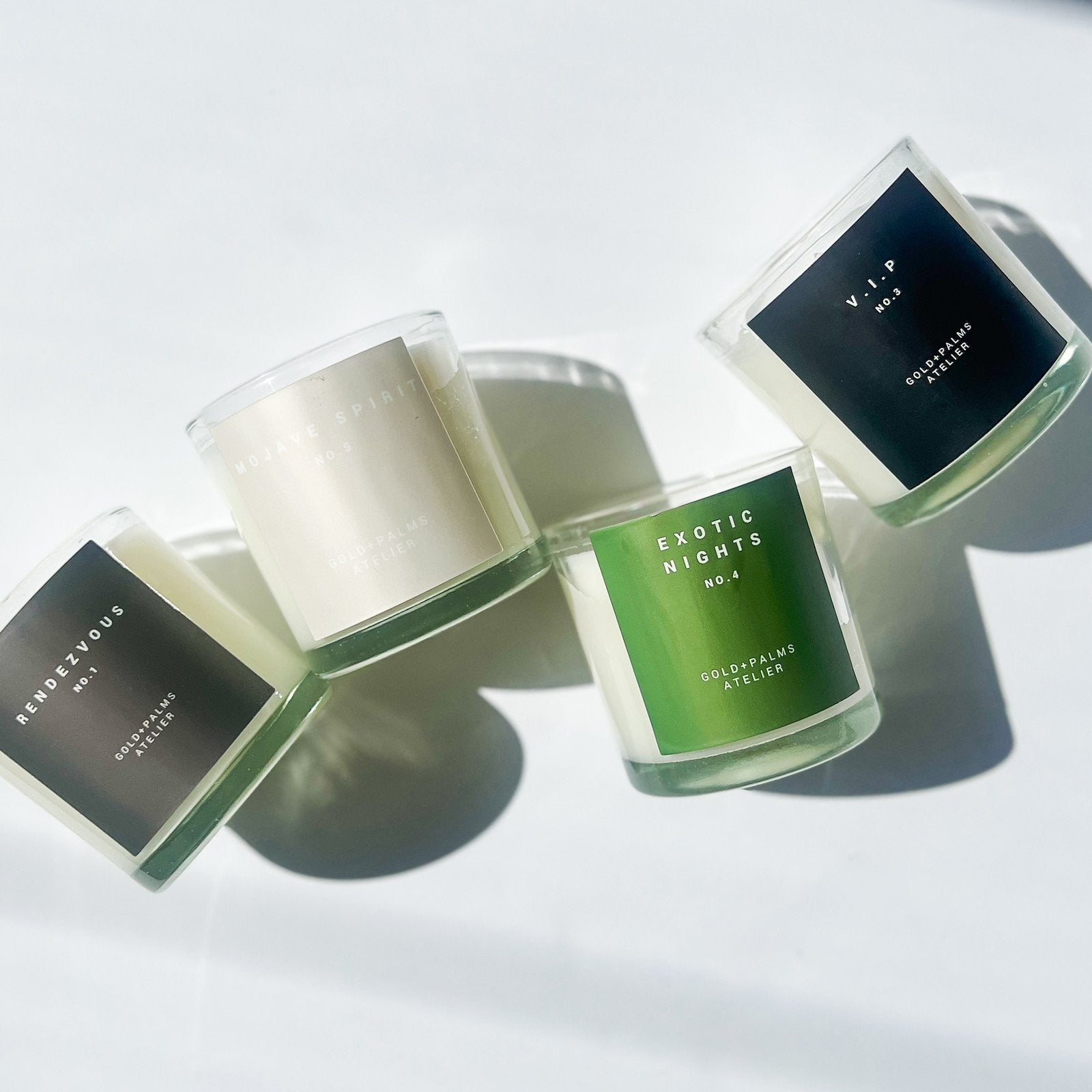 hotel inspired candle collection with neutral colored labels against white background