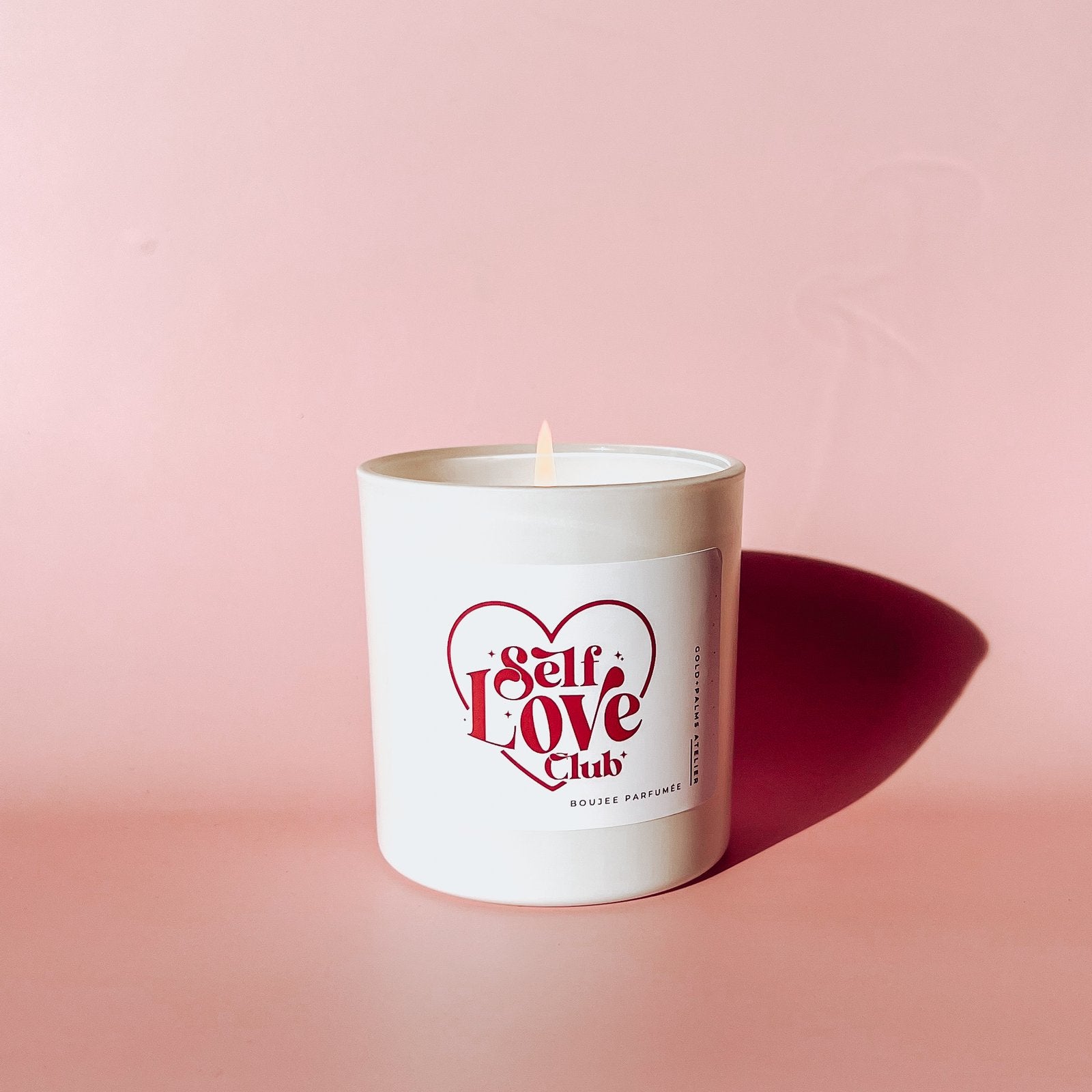 self love candle with pink background 