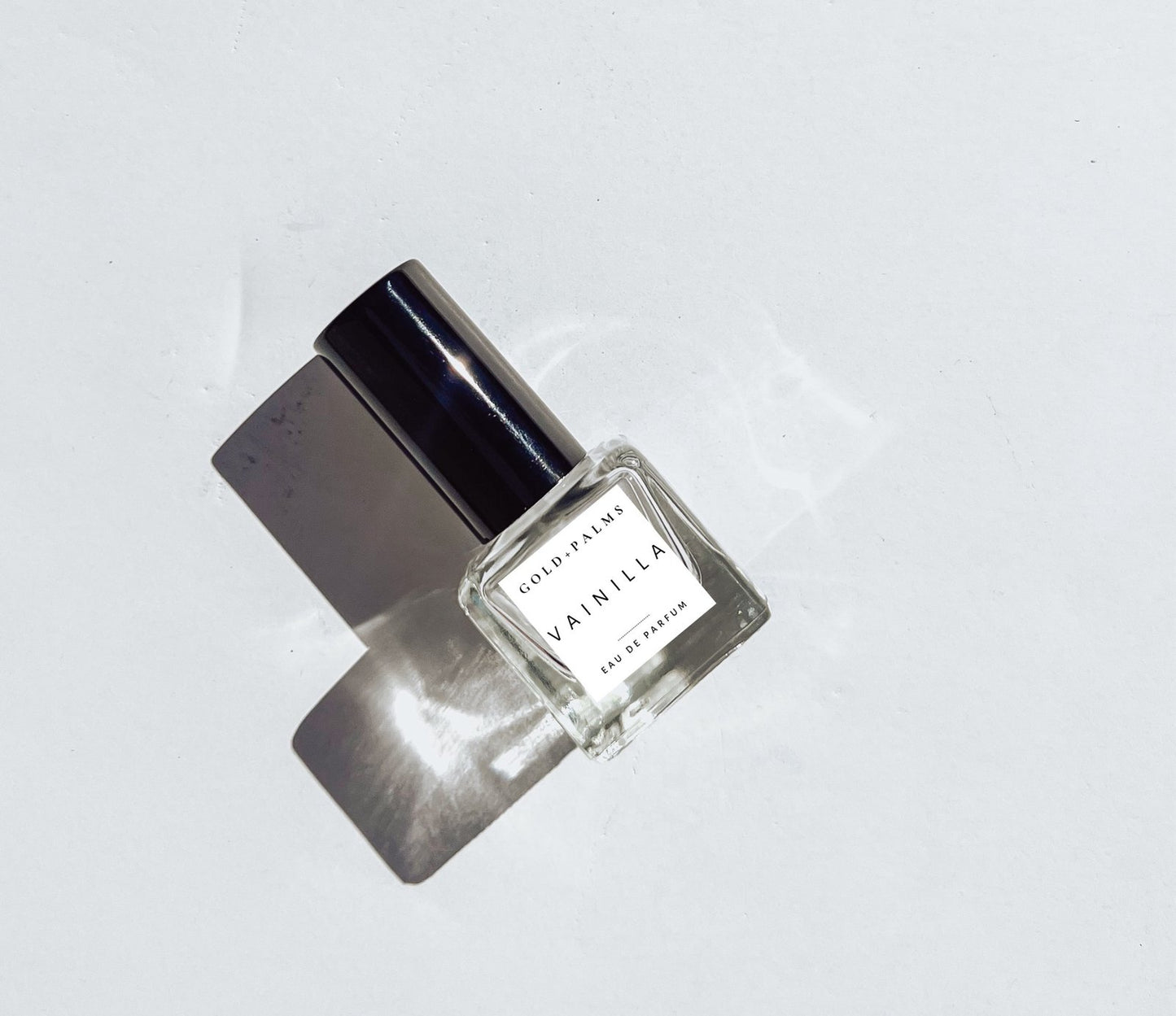 15 ml smokey vanilla perfume glistening with white background