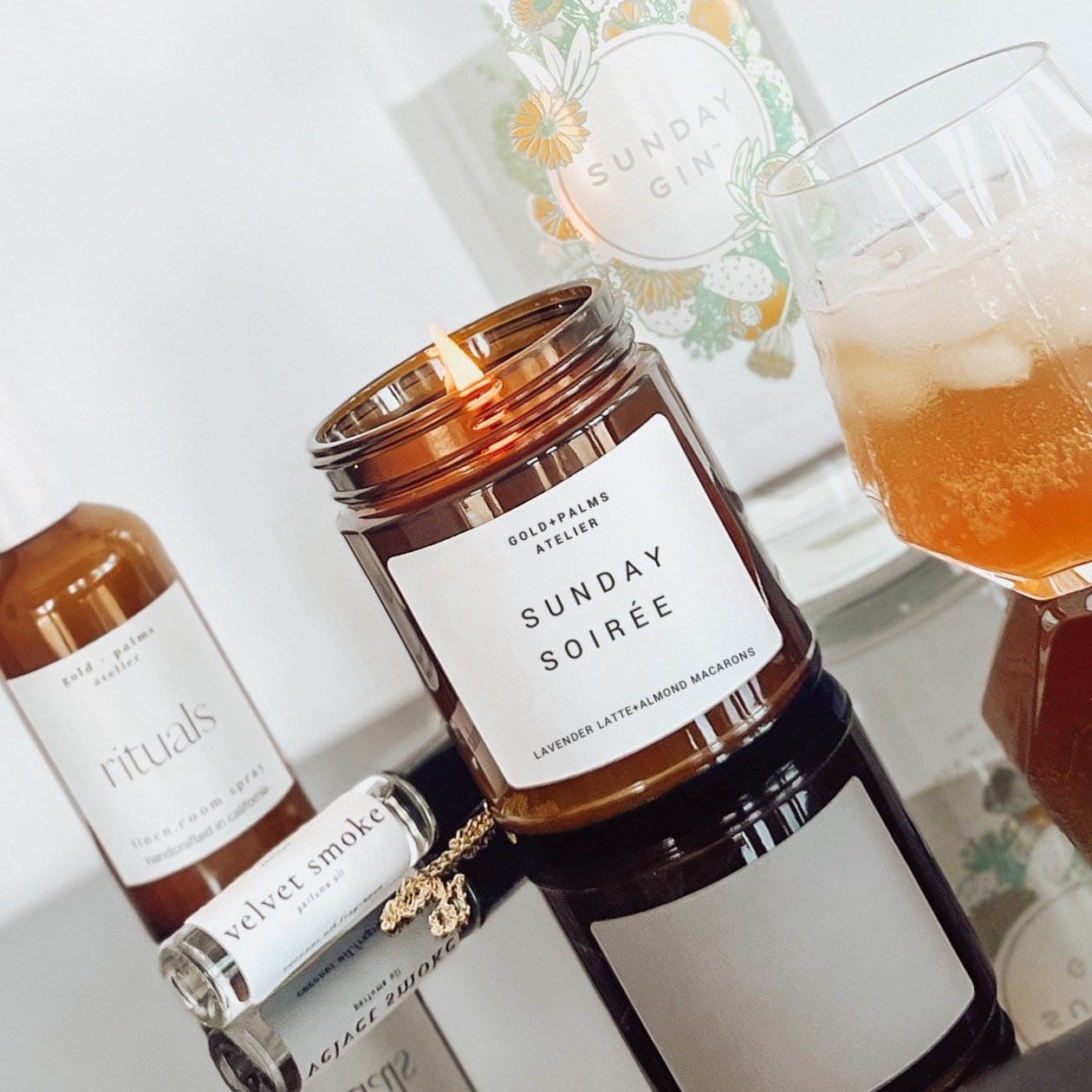 lavender latte soy candle in amber jar on glass counter